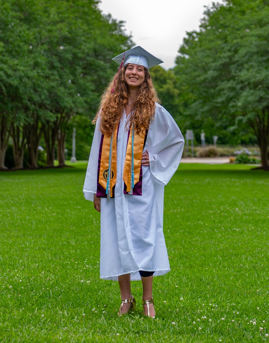Graduate in cap and gown celebrating academic success